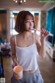 A woman brushing her teeth with a toothbrush.