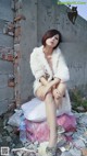 A woman sitting on top of a pile of trash.