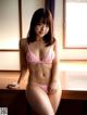 A woman in a pink lingerie posing for a picture.