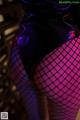 A close up of a person wearing fishnet stockings.